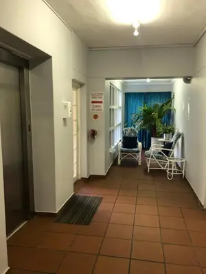 an empty hallway with chairs and a table at Relaxing Hideaway in Strand