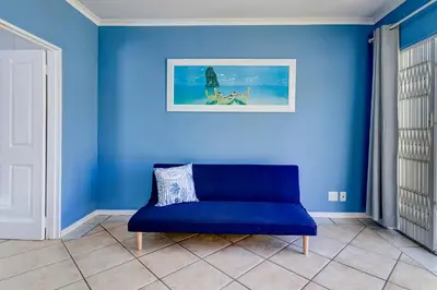 a blue wall with a blue couch in a room at Sea Breeze Kite Dreams 1 in Cape Town