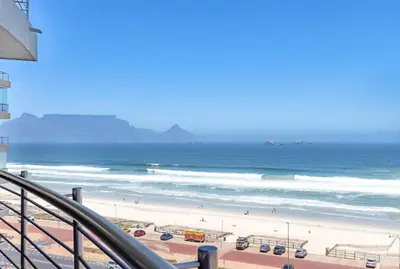 a view of a beach with people and the ocean at Beachfront Apt Kite Beach with Table Mtn View Horizon Bay 501 in Cape Town