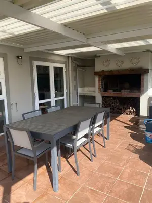 a wooden table and chairs on a patio at Cape Town in Cape Town