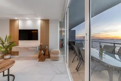 a living room with a view of the ocean at Beautiful 3 bed apartment with sea views Horizon Bay 502 in Cape Town