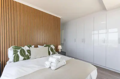 a bedroom with a large bed with towels on it at Horizon Haven with stunning view by HMH 803 in Cape Town