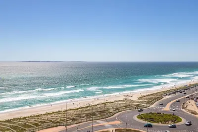 a road next to the beach and the ocean at Horizon Haven with stunning view by HMH 803 in Cape Town