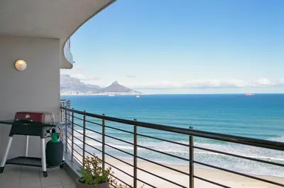 a balcony with a view of the ocean at Chic Beachfront Apt with Table Mountain Views Horizon Bay 902 in Cape Town