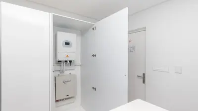 a white bathroom with a shower and a sink at Horizon Bay 1302 Loadshedding Free APT by HMH in Cape Town