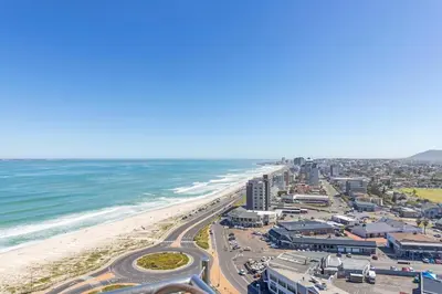an aerial view of a beach and the ocean at Modern Sea View Retreat with Pool & Inverter Horizon Bay 1405 in Cape Town