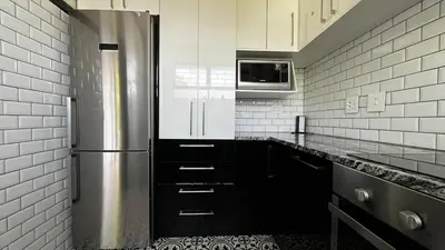 a kitchen with a stainless steel refrigerator and a microwave at Homey Central Apartment By ARPA in Stellenbosch