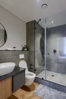a bathroom with a shower and a toilet and a sink at Luxe On Park Century City in Cape Town