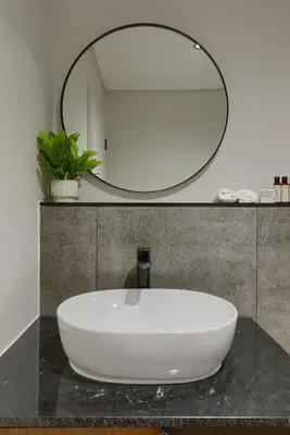 a bathroom sink with a large mirror on a counter at Luxe On Park Century City in Cape Town