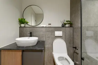 a bathroom with a sink and a toilet and a mirror at Luxe On Park Century City in Cape Town
