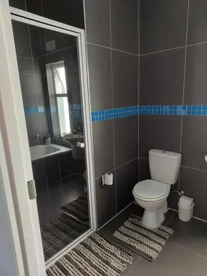 a bathroom with a toilet and a sink and a shower at Chelmsford Close Pinehurst - Excellent location! in Oakdale