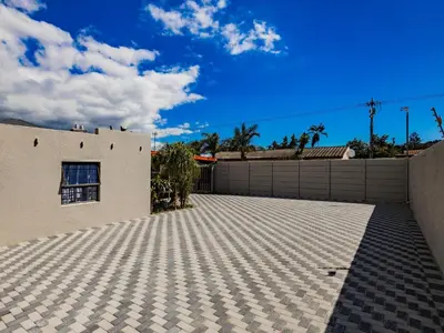 a house with a tile driveway in front of a fence at Urban Oaks in Bellville