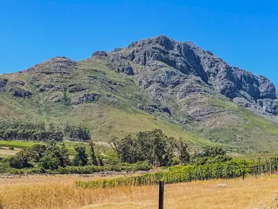 a mountain with a fence in front of it at Spacious mountain-view haven in Stellenbosch