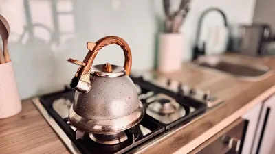 a tea kettle on a stove in a kitchen at 2 Bedroom, 4 Sleeper Hidden Gem Minutes from Blouberg Beach Front in Cape Town