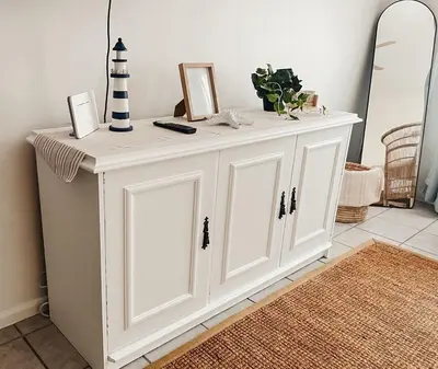 a white cabinet in a room with a lighthouse at Cozy one bed, just a short walk to the beach in Strand
