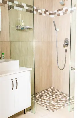 a bathroom with a shower with a sink and a toilet at Campbell's Corner in Cape Town