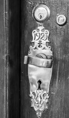 a wooden door with a metal door knocker on it at Campbell's Corner in Cape Town