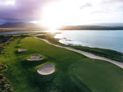 an aerial view of a golf course next to the water at Arabella Hotel, Golf and Spa in Kleinmond