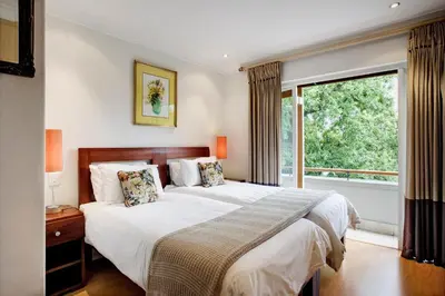 a bedroom with a large bed and a window at The Stellenbosch Hotel in Stellenbosch