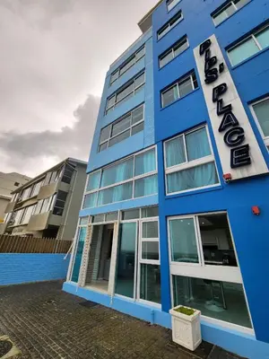 a blue building with a sign on it at Seaview Serenity Strand in Strand