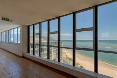 a room with a view of a beach and the ocean at Ashley On Beach 1104 Prestige Style in Strand
