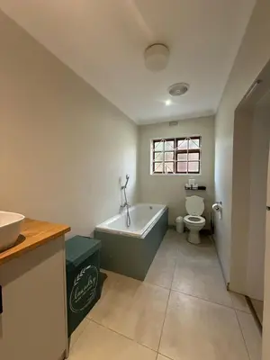 a bathroom with a tub and a toilet and a sink at Spacious 3 Bedroom 2 Bathroom 6 Sleeper in Southfield