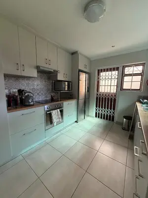 a large kitchen with white cabinets and appliances at Spacious 3 Bedroom 2 Bathroom 6 Sleeper in Southfield