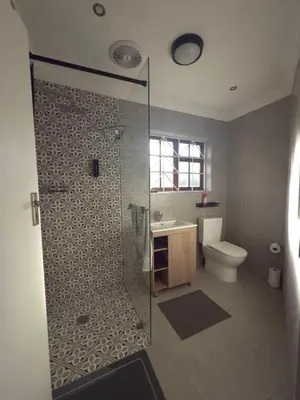 a bathroom with a shower with a toilet and a sink at Spacious 3 Bedroom 2 Bathroom 6 Sleeper in Southfield