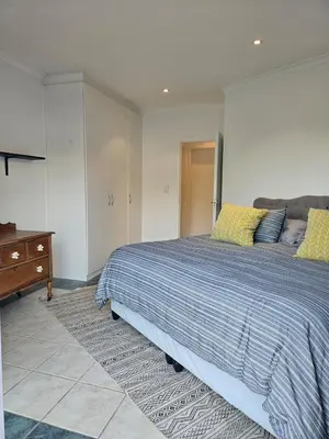 a bedroom with a large bed and a dresser at Fair View 2 in Somerset West