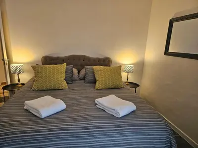 a bed with two pillows on top of it at Fair View 2 in Somerset West