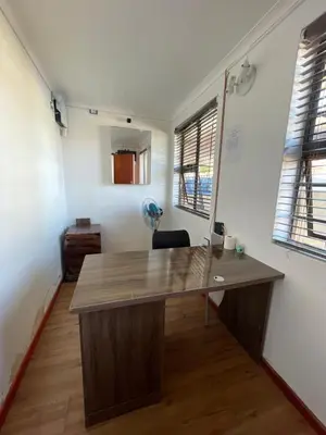 an office with a desk in a room with windows at Lookout 12 Duminy Guesthouse in Avondale
