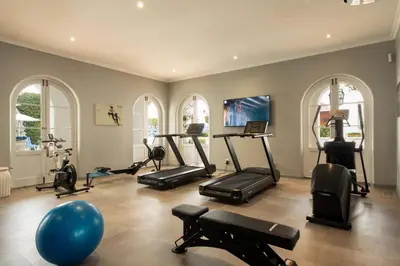 a gym with several treadmills and exercise bikes at The Marine Hermanus in Hermanus