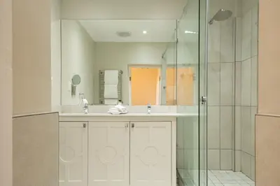 a bathroom with a sink and a shower at The Marine Hermanus in Hermanus