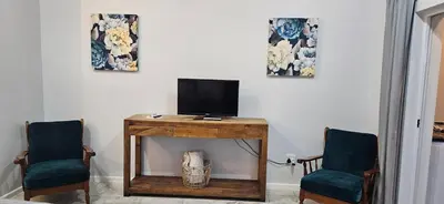 a room with two chairs and a television on a table at Fair View in Somerset West