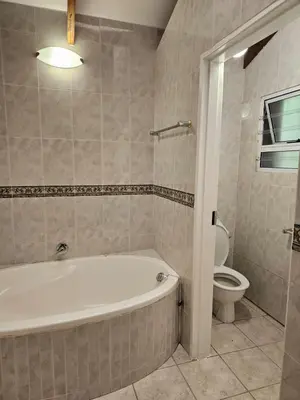a bathroom with a tub and a toilet at Fair View in Somerset West