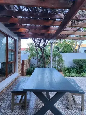 a picnic table under a pergola on a patio at 51 on 6th in Hermanus