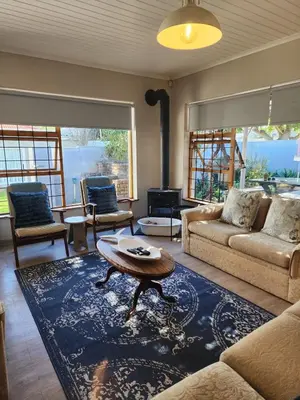 a living room with a couch and a table at 51 on 6th in Hermanus