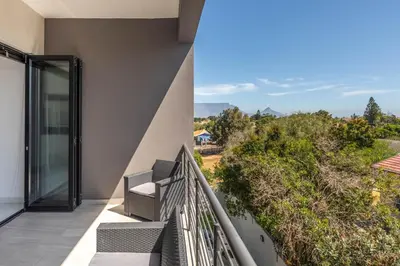 a balcony with a view of the mountains at Greystone Serenity 2-Bedroom Apartment in Cape Town