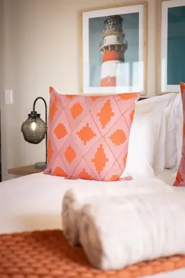 a bedroom with a bed with a red and white lighthouse at Waterfront Studios - Hermanus Waterfront Apartments in Hermanus
