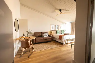 a living room with a couch and a bed at Waterfront Studios - Hermanus Waterfront Apartments in Hermanus