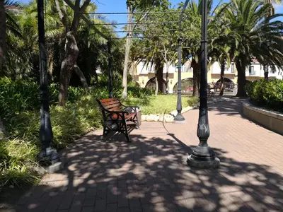 a park bench sitting next to a street light at Majorca Apartments by BON Hotels in Cape Town
