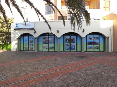 a building with many windows and a palm tree at Majorca Apartments by BON Hotels in Cape Town
