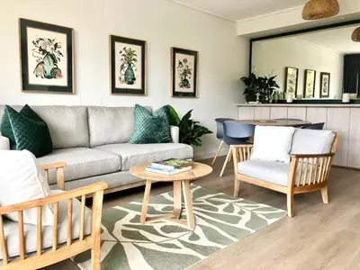a living room with a couch and chairs and a table at The Wild Oak in Hermanus