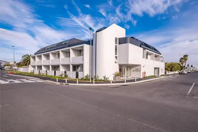 a white building on the side of a road at The Wild Oak in Hermanus