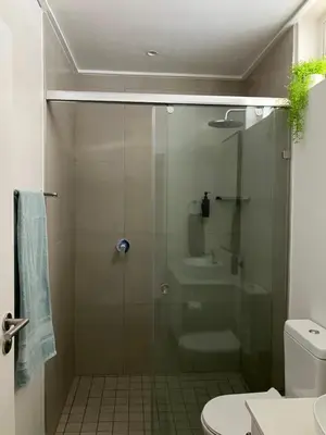 a bathroom with a glass shower with a toilet and a sink at The Wild Oak in Hermanus