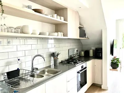 a white kitchen with a sink and a counter at The Wild Oak in Hermanus