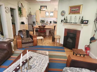 a living room with a couch and a fireplace at Strand Beach House in Strand