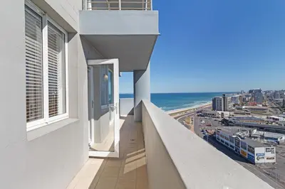 a balcony of a building with a view of the ocean at Stylish 2-Bedroom Sea-View Apartment Horizon Bay Blouberg Beachfront in Cape Town