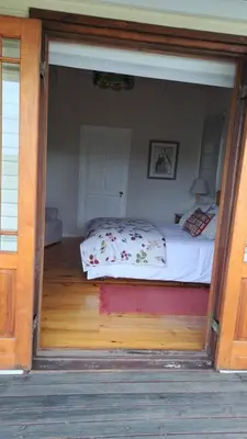 a bedroom with a bed in the middle of a room at Glengarry in Grabouw