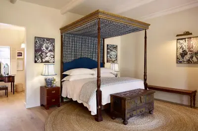 a bedroom with a four poster bed with a canopy at Spier Hotel and Wine Farm in Stellenbosch